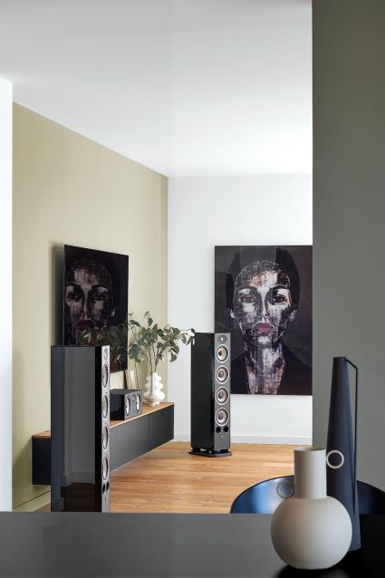 High-end audio equipment with black speakers and wooden accents